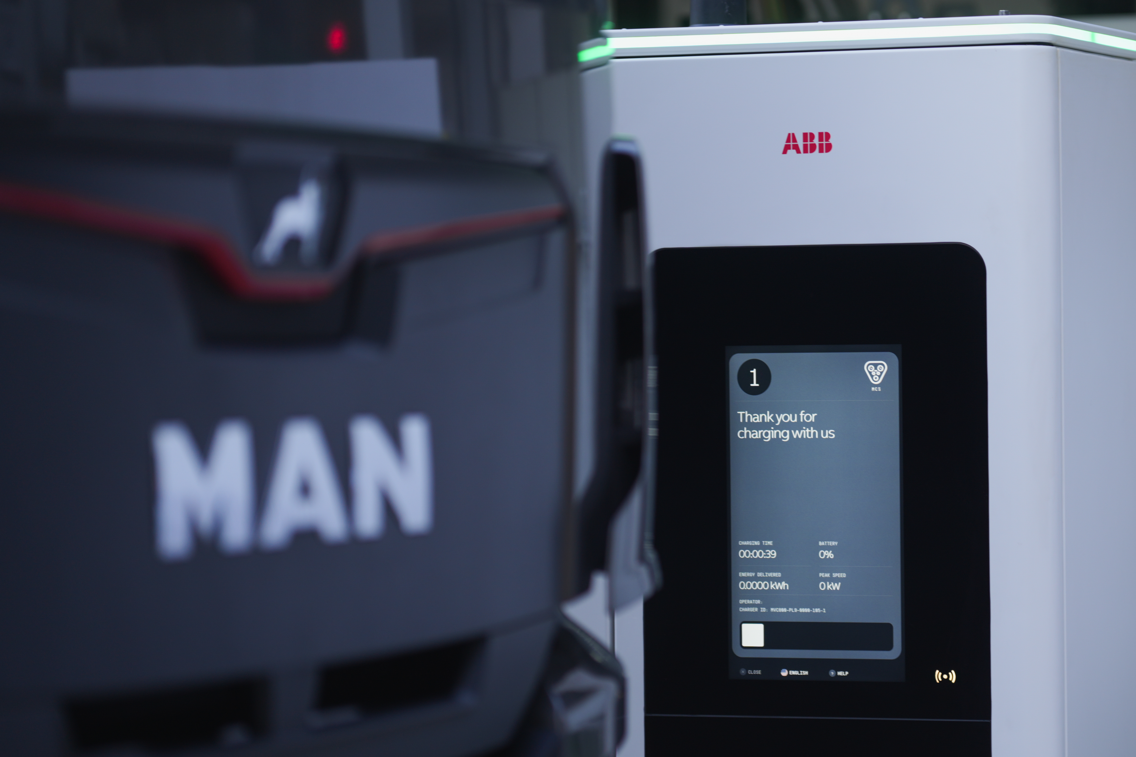 MCS1200 charger ready for use at a truck-charging bay where a driver checks his truck
