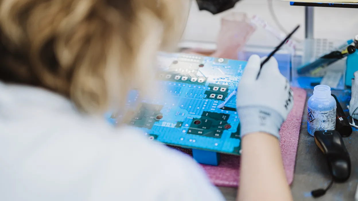 Technician inspecting electronic components