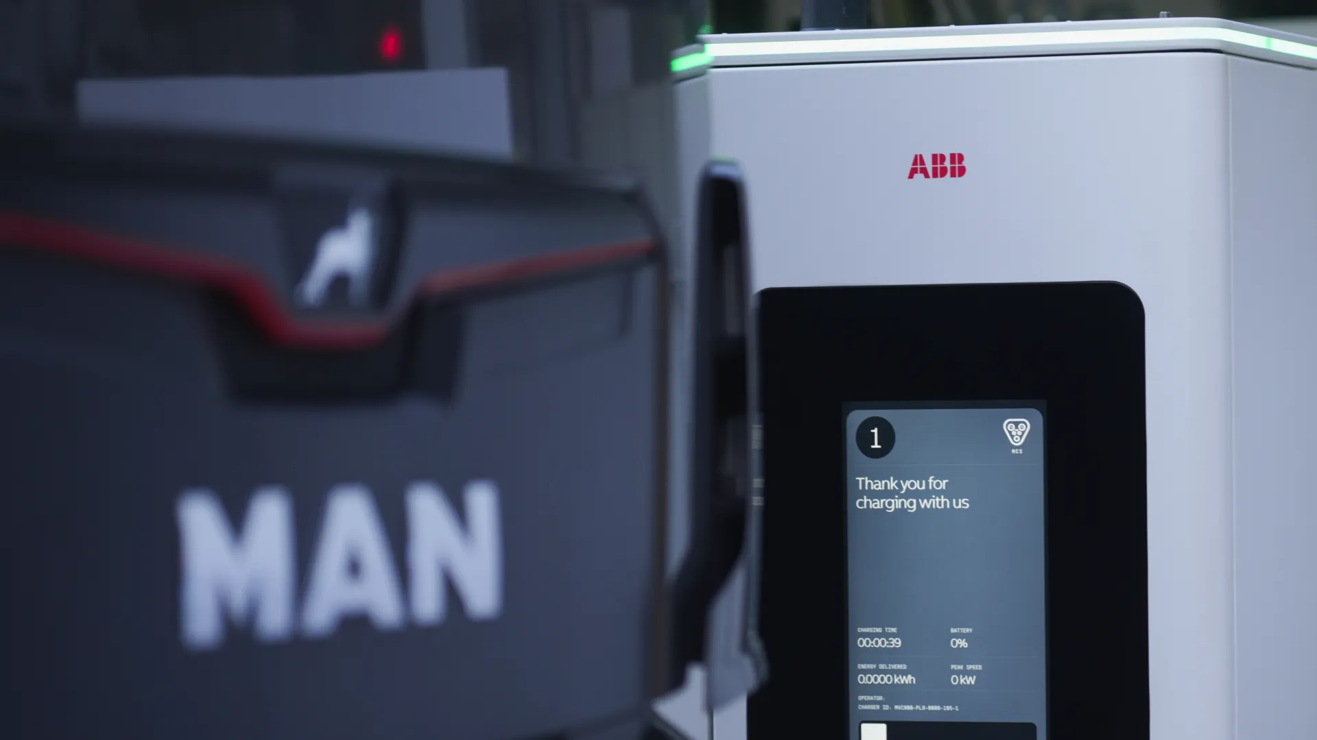 MCS1200 charger ready for use at a truck-charging bay where a driver checks his truck