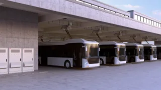 Electric buses charging in a row at a bus depot