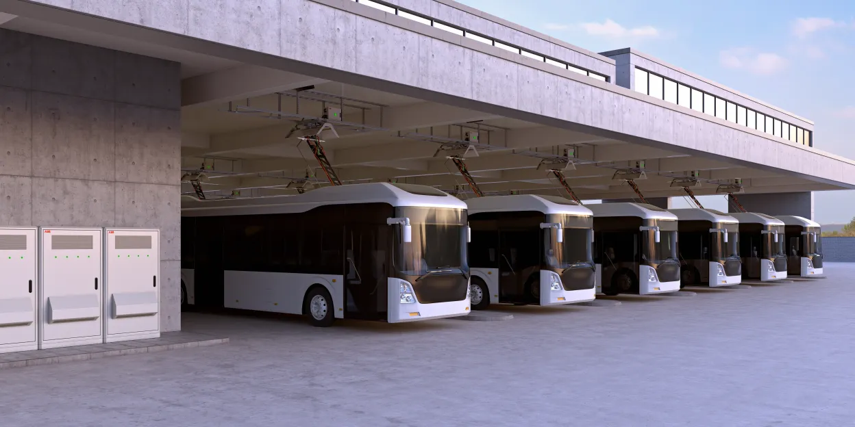 Electric buses charging in a row at a bus depot