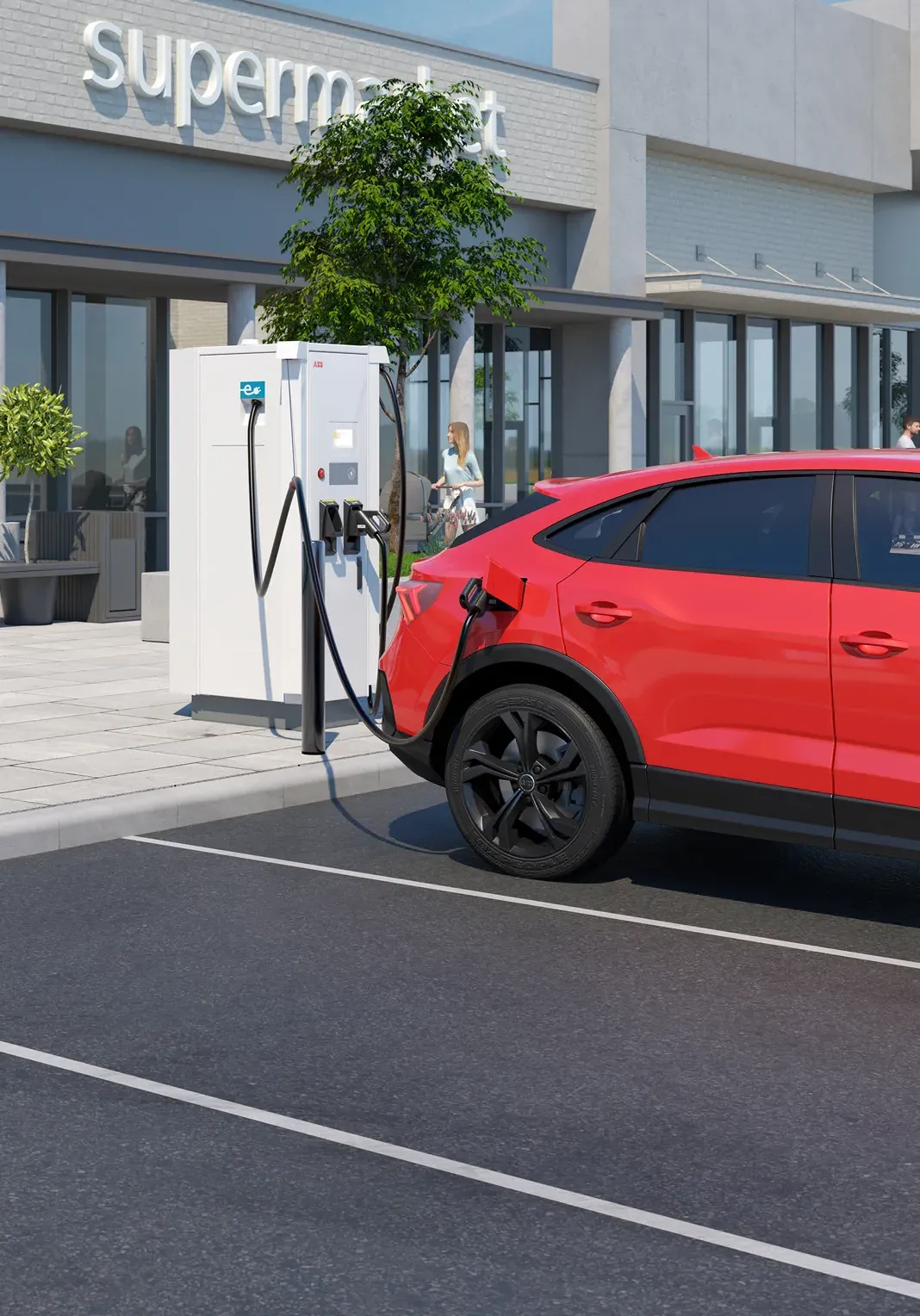 An electric vehicle is plugged into a T184 charger outside a commercial building