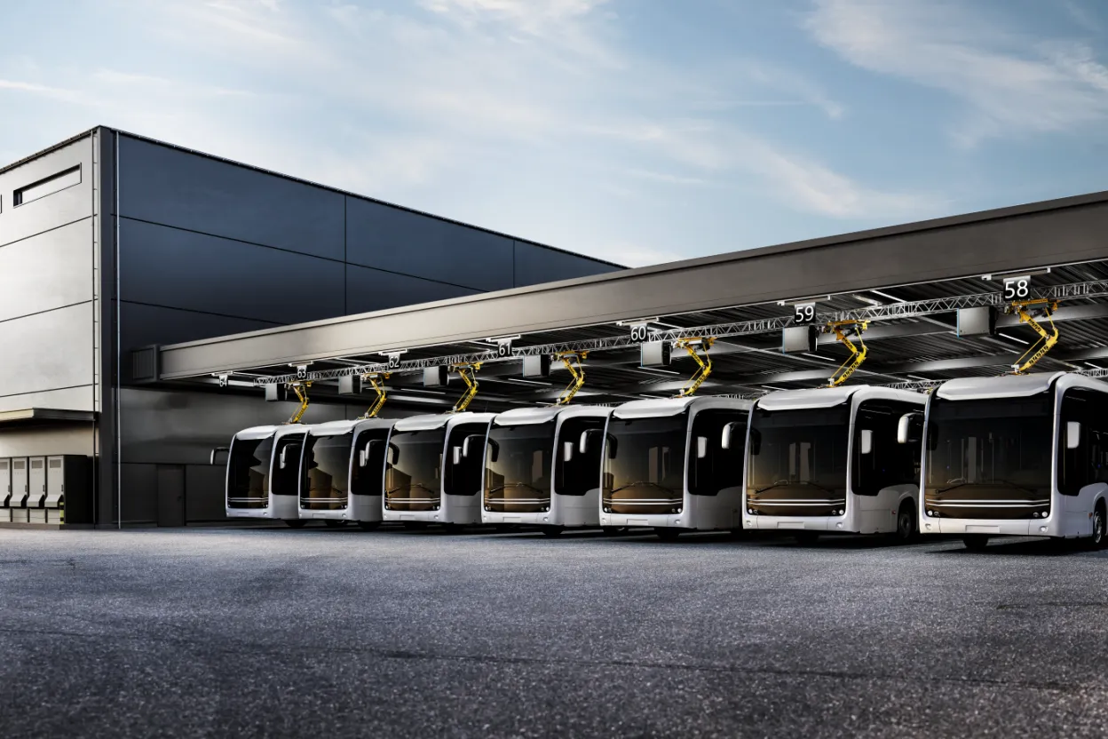 A fleet of buses charge using panto-down systems in a bus depot