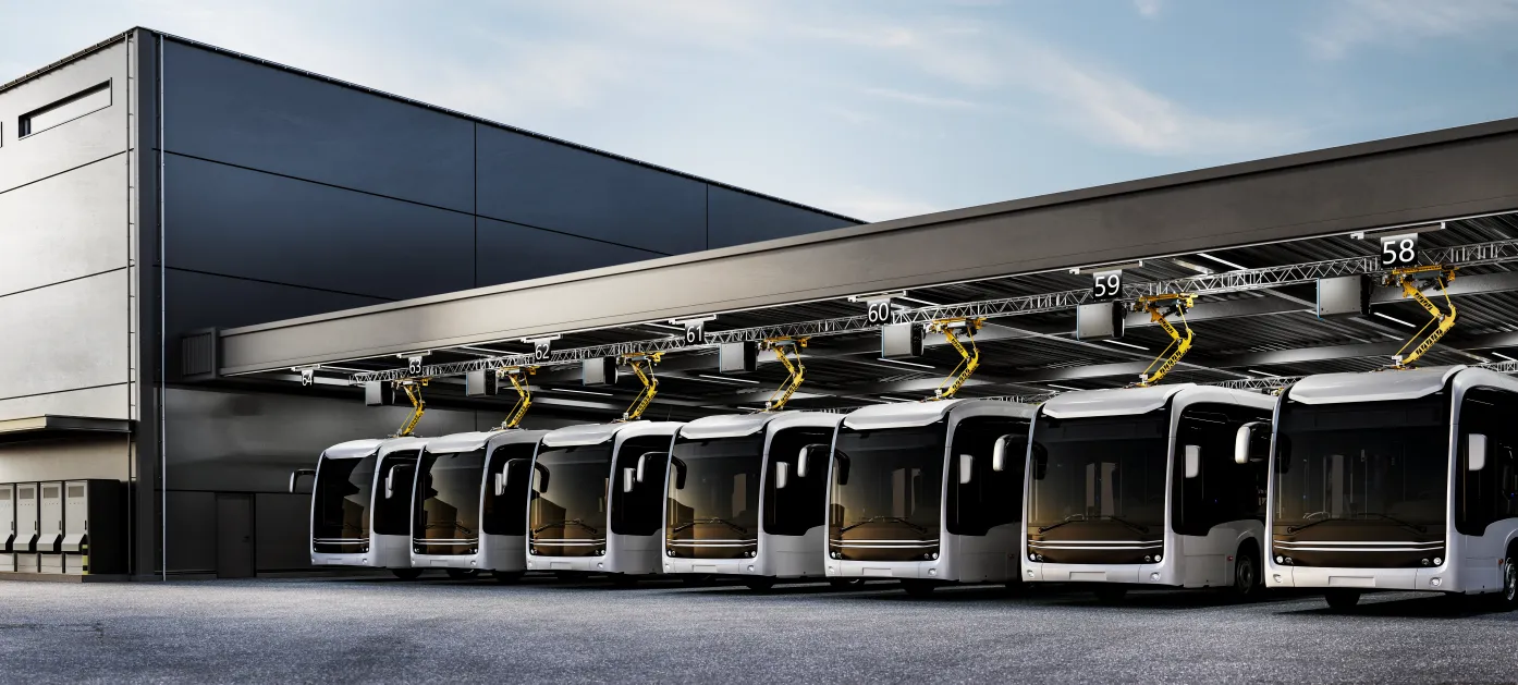 Electric buses charging in a row at a bus depot