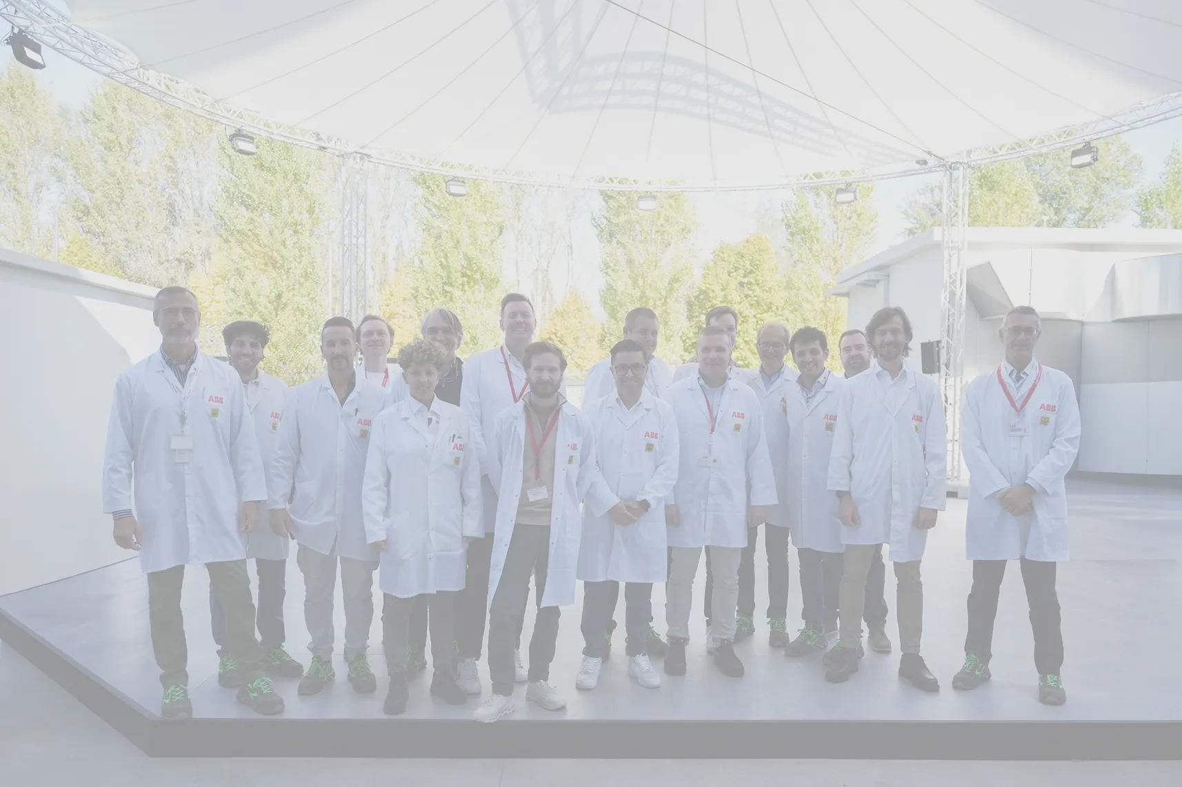A large group of ABB E-mobility employees in lab coats